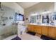 This bathroom has a double sink vanity with a glass shower and bathtub at 7517 Elk Meadows Ct, Las Vegas, NV 89131
