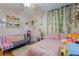 Bright bedroom featuring a unique décor with decorative shelves and a cozy seating area at 7517 Elk Meadows Ct, Las Vegas, NV 89131
