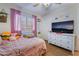 Bedroom with large window, neutral paint, and white dresser topped with a flatscreen TV at 7517 Elk Meadows Ct, Las Vegas, NV 89131