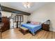 Primary bedroom featuring a large bed, wooden floors, and natural light at 7517 Elk Meadows Ct, Las Vegas, NV 89131
