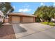Beautiful single-story home with a long driveway, spacious two-car garage, and colorful landscaping at 7517 Elk Meadows Ct, Las Vegas, NV 89131
