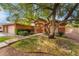 Inviting single-story home featuring lush landscaping, mature trees, and a welcoming front entrance at 7517 Elk Meadows Ct, Las Vegas, NV 89131