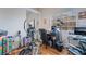 This home office features hardwood floors, natural light, and an exercise machine at 7517 Elk Meadows Ct, Las Vegas, NV 89131
