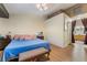 This main bedroom features hardwood floors, a ceiling fan, and an ensuite bathroom at 7517 Elk Meadows Ct, Las Vegas, NV 89131