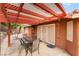 Covered patio area ideal for outdoor dining and relaxation with table and chair set at 7517 Elk Meadows Ct, Las Vegas, NV 89131