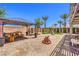 Backyard featuring a pergola, hardscape, playground, and desert landscaping at 7902 Jessamy St, North Las Vegas, NV 89084