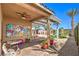 Entertaining backyard features a covered patio, lush greenery, and a custom playset at 7902 Jessamy St, North Las Vegas, NV 89084