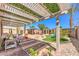 Backyard oasis features lush greenery, custom playset, swing set, covered seating, and mature landscaping at 7902 Jessamy St, North Las Vegas, NV 89084
