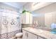 Bright bathroom features granite counters, decorative shower curtain, and white cabinets for a clean, modern look at 7902 Jessamy St, North Las Vegas, NV 89084