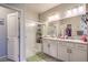 Bathroom featuring double sinks, granite counters and glass enclosed shower at 7902 Jessamy St, North Las Vegas, NV 89084