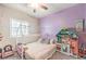 Bedroom featuring a ceiling fan, large window with shutters, and carpet at 7902 Jessamy St, North Las Vegas, NV 89084