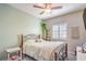 Bedroom featuring a ceiling fan, large window with shutters, and carpet at 7902 Jessamy St, North Las Vegas, NV 89084
