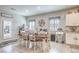 Bright dining area featuring a wooden table, white chairs, and modern decor accents at 7902 Jessamy St, North Las Vegas, NV 89084