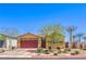 Charming single-story home boasts a red garage door, desert landscaping, and a welcoming entrance at 7902 Jessamy St, North Las Vegas, NV 89084