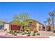 Single story home with drought-tolerant landscaping, red garage door, and gated side yard at 7902 Jessamy St, North Las Vegas, NV 89084