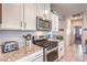 Kitchen with stainless steel appliances, white cabinets and stylish hardware at 7902 Jessamy St, North Las Vegas, NV 89084