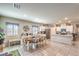 Open floor plan featuring the dining area and kitchen with white cabinetry at 7902 Jessamy St, North Las Vegas, NV 89084