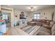 Inviting living room featuring tile floors, a ceiling fan, and abundant natural light at 7902 Jessamy St, North Las Vegas, NV 89084