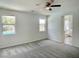 Spacious bedroom with carpet, ceiling fan, and views of the backyard pool at 8084 Black Orchid Ave, Las Vegas, NV 89131