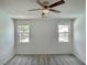 Bright bedroom with carpet, ceiling fan, and natural light from two windows at 8084 Black Orchid Ave, Las Vegas, NV 89131