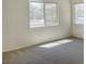 Spacious bedroom with large windows and neutral colored carpet, allowing ample natural light at 8084 Black Orchid Ave, Las Vegas, NV 89131