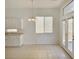 Bright kitchen nook features white cabinets, tile floors, and sliding glass door at 8084 Black Orchid Ave, Las Vegas, NV 89131