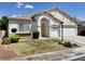 Well-maintained single-story home with a three-car garage and desert-friendly front yard landscaping at 8084 Black Orchid Ave, Las Vegas, NV 89131