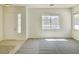 Bright living room with neutral paint, large windows, and a combination tile and carpet flooring at 8084 Black Orchid Ave, Las Vegas, NV 89131