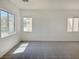 Expansive living room with neutral walls, carpet, and plenty of natural light from multiple windows at 8084 Black Orchid Ave, Las Vegas, NV 89131