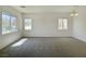 Bright living room with natural light and a classic chandelier over neutral carpet at 8084 Black Orchid Ave, Las Vegas, NV 89131