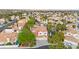 An aerial view showcasing a home with a red tile roof, pool, landscaping, and a community lake at 8117 Horizon Lake Dr, Las Vegas, NV 89128