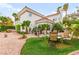 Back exterior shows a home with well manicured landscaping, stone, and a circular window at 8117 Horizon Lake Dr, Las Vegas, NV 89128