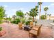 Landscaped backyard features decorative rock, mature palms and a central fire pit at 8117 Horizon Lake Dr, Las Vegas, NV 89128