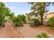 Backyard featuring a gravel landscape with desert plants, stone path, and seating at 8117 Horizon Lake Dr, Las Vegas, NV 89128