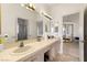 Bright bathroom featuring a double sink vanity with ample counter space and mirrored wall at 8117 Horizon Lake Dr, Las Vegas, NV 89128