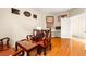Bright bedroom featuring hardwood floors, a desk, and three Asian style wood chairs at 8117 Horizon Lake Dr, Las Vegas, NV 89128
