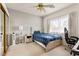 Cozy bedroom with carpet, ceiling fan, and a well lit window offering natural lighting at 8117 Horizon Lake Dr, Las Vegas, NV 89128