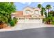 Charming stucco home with a tile roof, three-car garage, and mature landscaping at 8117 Horizon Lake Dr, Las Vegas, NV 89128