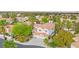 Aerial shot of a home featuring a red tile roof, palm trees, a three-car garage, and manicured landscaping at 8117 Horizon Lake Dr, Las Vegas, NV 89128