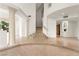 Spacious foyer with tile flooring, decorative columns, and a staircase leading to the second floor at 8117 Horizon Lake Dr, Las Vegas, NV 89128