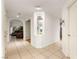 Bright hallway with tiled floors, arched entryway, and built-in display niche at 8117 Horizon Lake Dr, Las Vegas, NV 89128