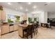 Well-lit kitchen with granite counters, island seating, fireplace and adjacent dining area at 8117 Horizon Lake Dr, Las Vegas, NV 89128