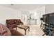 Spacious living room with tiled floors, ample seating, and an open layout at 8117 Horizon Lake Dr, Las Vegas, NV 89128