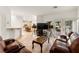 Bright, open-concept living room with tiled floors, generous seating, and backyard access at 8117 Horizon Lake Dr, Las Vegas, NV 89128