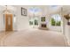 Bright living room with soaring ceilings, a fireplace, and multiple large windows at 8117 Horizon Lake Dr, Las Vegas, NV 89128