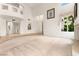 Large living room boasts high ceilings, neutral carpet, bright windows, and an open floor plan at 8117 Horizon Lake Dr, Las Vegas, NV 89128
