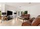 Comfortable living room with tiled floors, natural light, and a cozy seating area at 8117 Horizon Lake Dr, Las Vegas, NV 89128