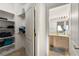 Walk-in closet with shelving, leading to a bathroom with neutral vanity at 8117 Horizon Lake Dr, Las Vegas, NV 89128