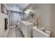 Bright bathroom featuring a double sink vanity with marble countertop and stylish decor at 902 Little Raven St, Henderson, NV 89002
