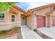 Inviting front entrance with a walkway leading to the doorway and access to the attached three-car garage at 902 Little Raven St, Henderson, NV 89002